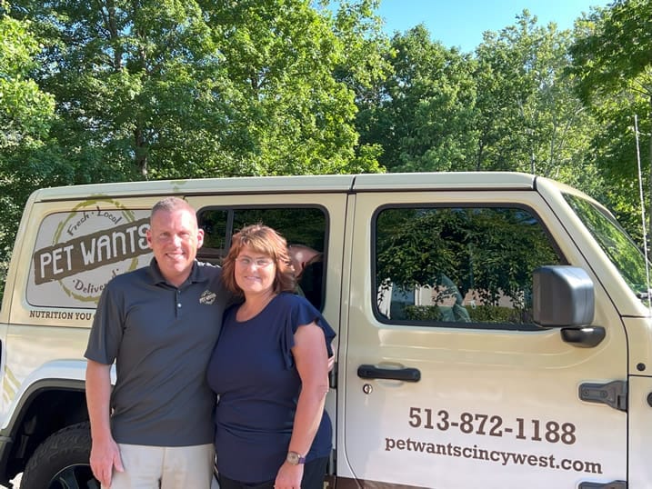 Pet Wants owners beside their delivery van