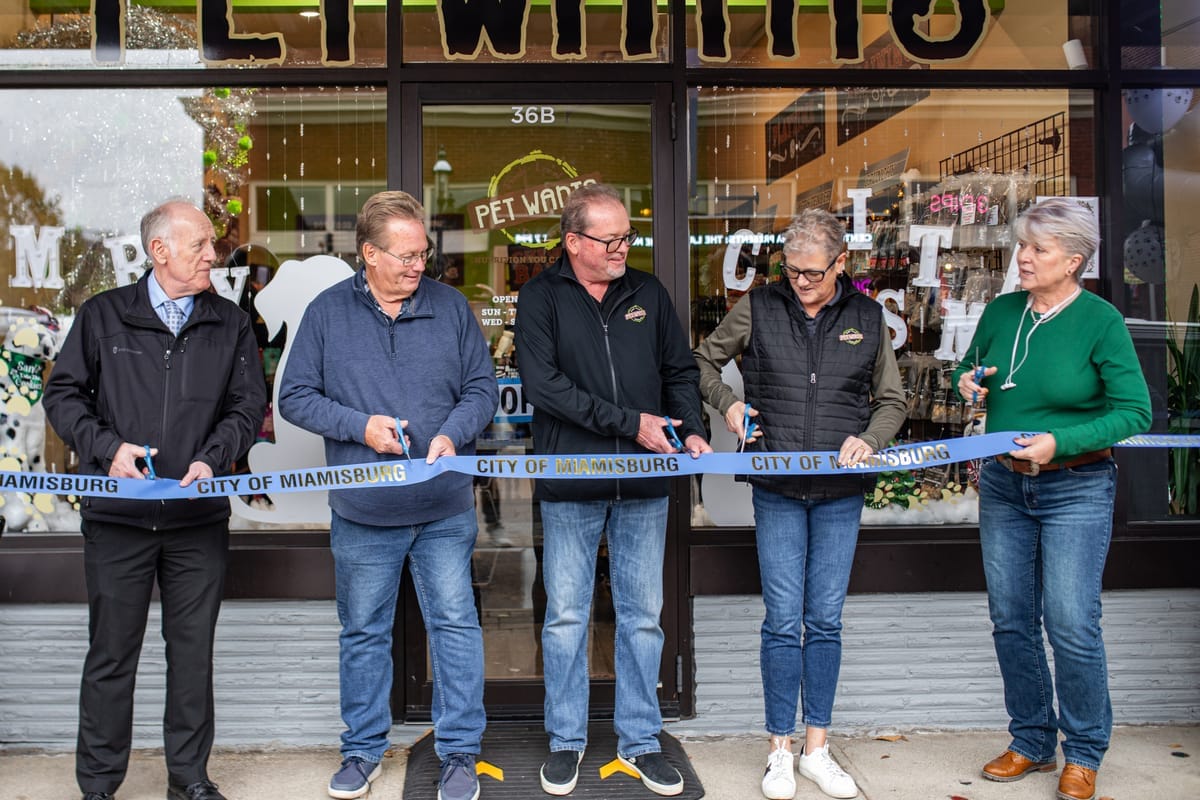 Pet Wants owners cutting the ribbon at a new store